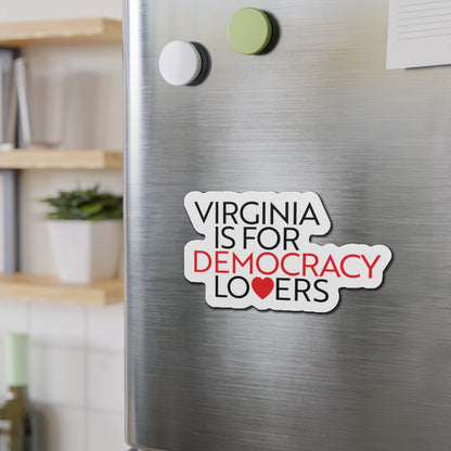 Fridge magnet with 'Virginia is for Democracy Lovers' text on a metallic surface.