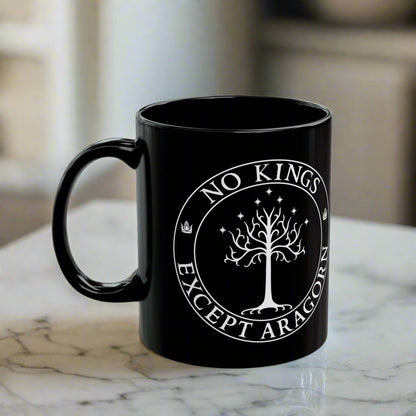 Black mug with the text "No kings except Aragorn" and a graphic featuring the white tree of Gondor with seven stars above it and the kings' crown.