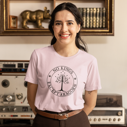 A woman wearing a pink t-shirt with the text "No kings except Aragorn" with a graphic of the white tree of Gondor with seven stars above it and two crowns of the king of Gondor.